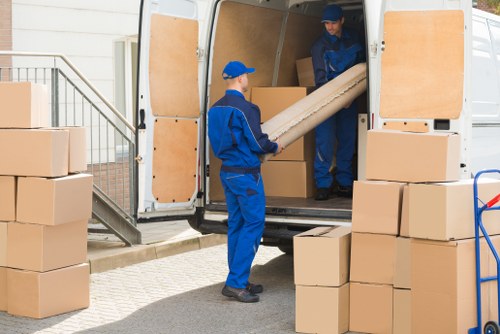 Man with van removal service loading household items in Hornchurch