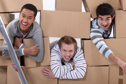 Local team collecting sofas, chairs, and cabinets from a Hornchurch property