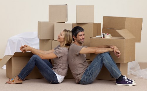 Removal team carrying furniture during a house move in Hornchurch