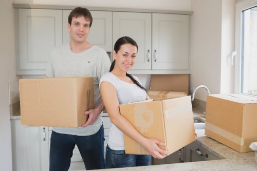 Local movers handling boxes and furniture in a Hornchurch home